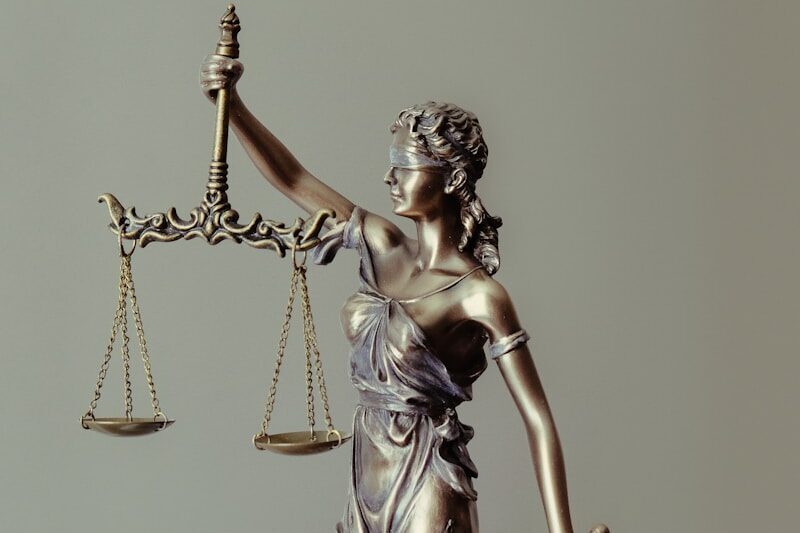 woman in gold dress holding sword figurine